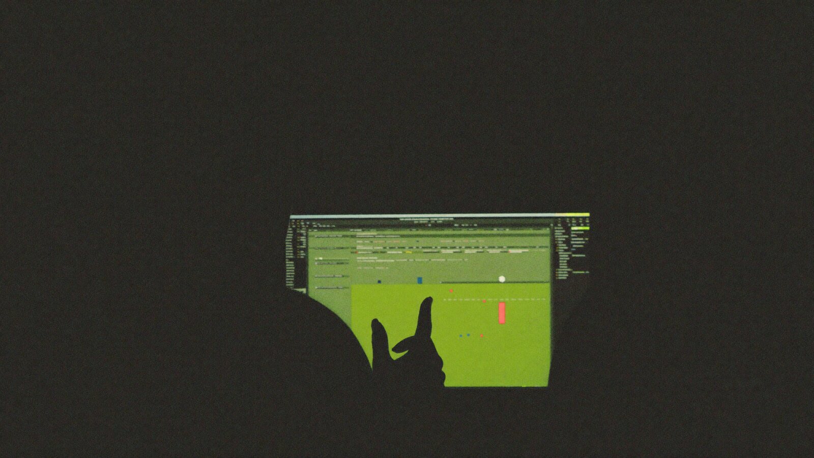 Working through data on a glowing screen in a dark studio