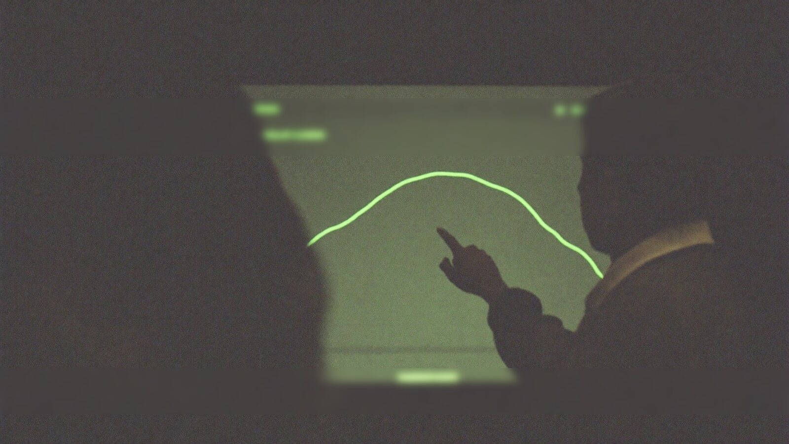 Two collaborators reviewing a data trend on a glowing screen